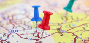 Pin on a paper map indicating a location