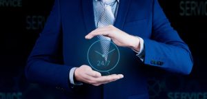 Man holding a watch indicating 24/7 availability