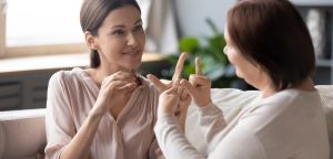 Two women communicating using sign language